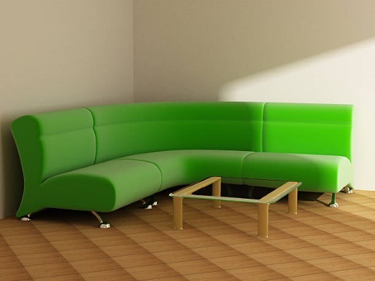 Sofá esquinero; mueble de color verde con patas plateadas